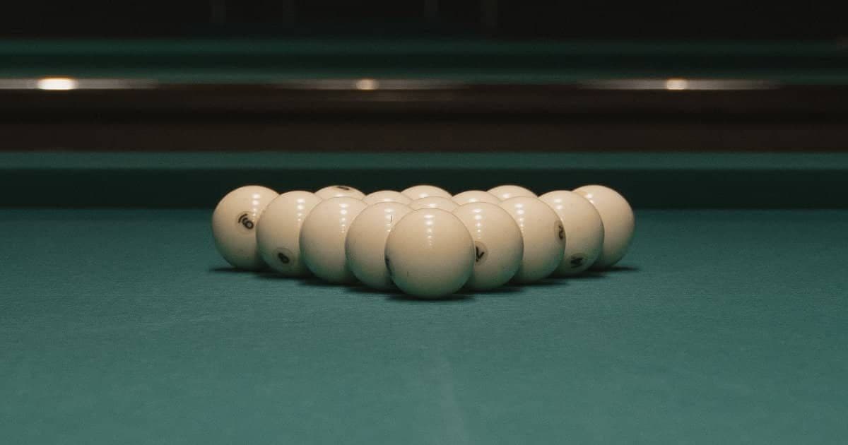Russian pyramid rack of white numbered balls seen at table level